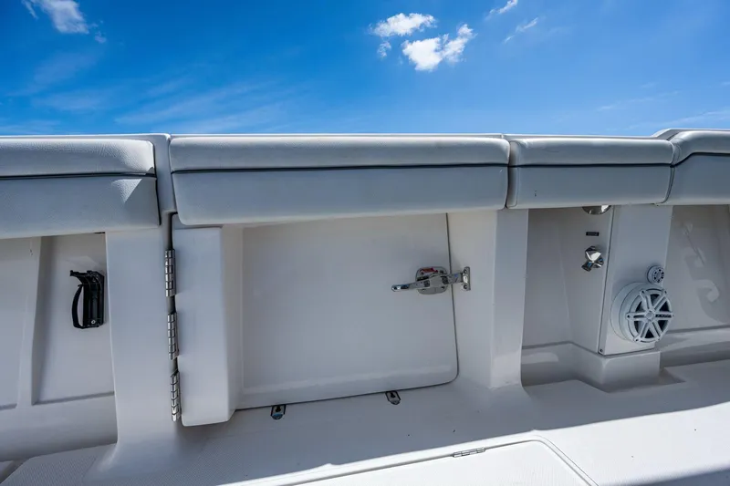  Yacht Photos Pics 2013 Jupiter 34 boat interior with storage compartment and speaker, under a clear blue sky.