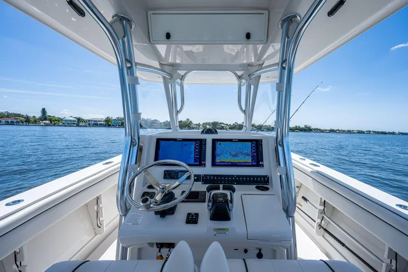  Yacht Photos Pics Helm of 2013 Jupiter 34 boat with dual screens, steering wheel, and ocean view.