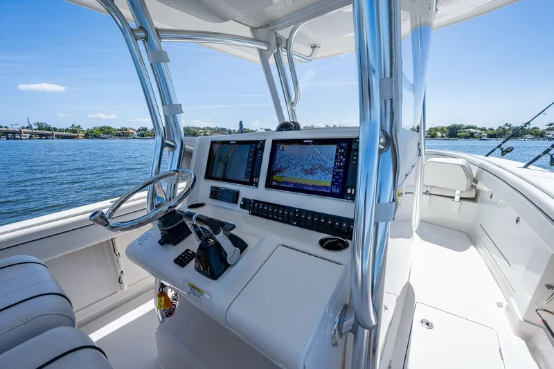  Yacht Photos Pics 2013 Jupiter 34 boat helm with navigation screens, steering wheel, and water view.