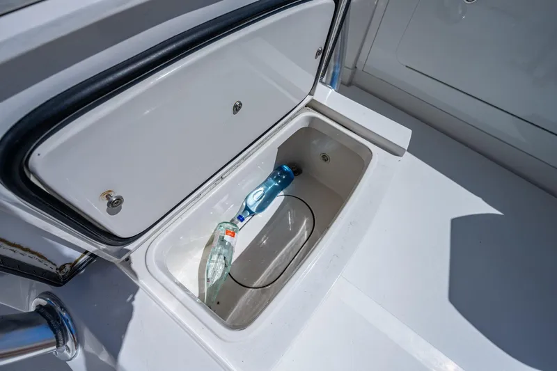  Yacht Photos Pics Open storage compartment on 2013 Jupiter 34 boat with water bottles inside.
