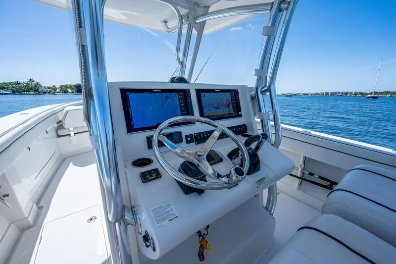  Yacht Photos Pics Cockpit of 2013 Jupiter 34 boat with dual navigation screens and steering wheel.