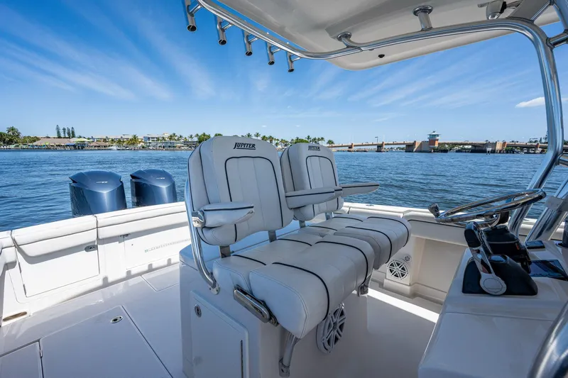  Yacht Photos Pics 2013 Jupiter 34 boat interior with dual engines, white seating, and ocean view.