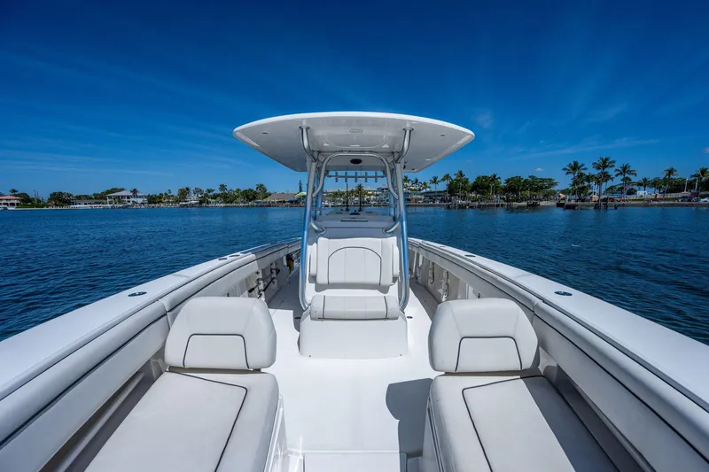  Yacht Photos Pics 2013 Jupiter 34 boat on calm water with clear blue sky and palm trees.