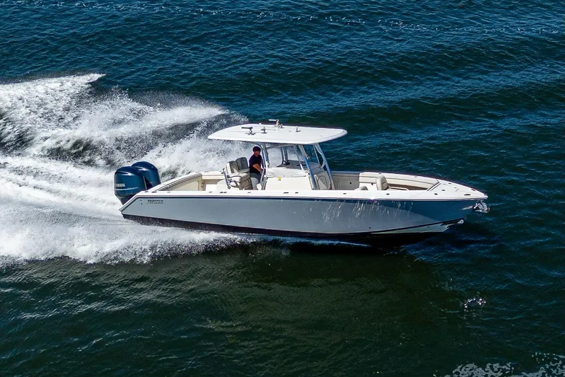  Yacht Photos Pics 2013 Jupiter 34 boat cruising on open water, creating a dynamic wake.