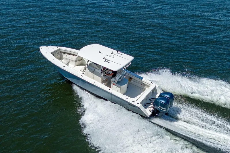  Yacht Photos Pics 2013 Jupiter 34 boat cruising on open water with twin Yamaha engines.