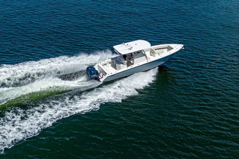  Yacht Photos Pics Aerial view of 2013 Jupiter 34 boat cruising on open water.