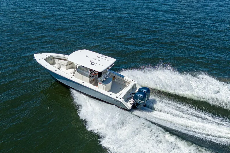  Yacht Photos Pics Aerial view of 2013 Jupiter 34 boat cruising on open water.