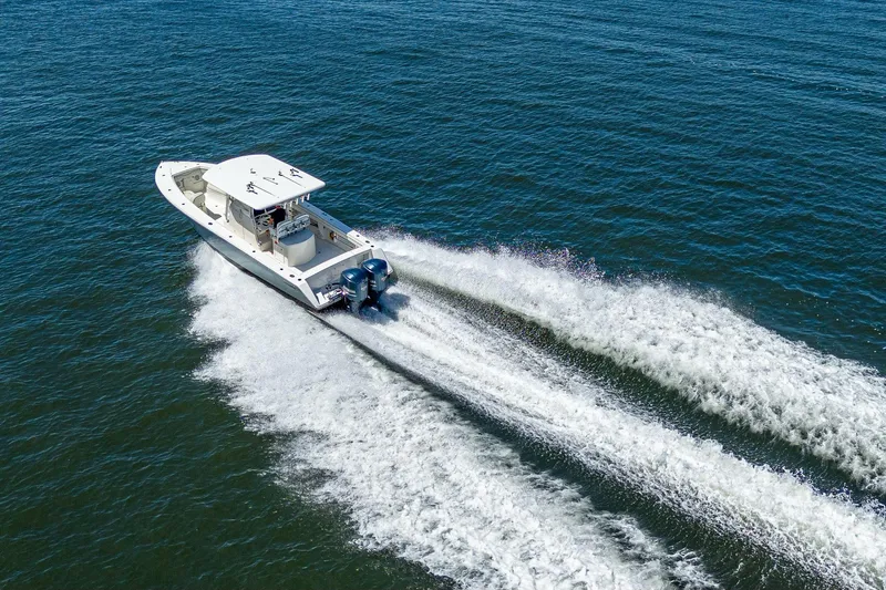  Yacht Photos Pics Aerial view of 2013 Jupiter 34 boat cruising on open water.