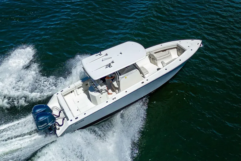  Yacht Photos Pics 2013 Jupiter 34 boat cruising on open water, aerial view.