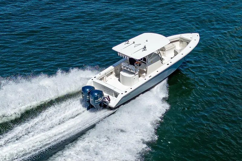  Yacht Photos Pics A 2013 Jupiter 34 boat cruising swiftly on open water.