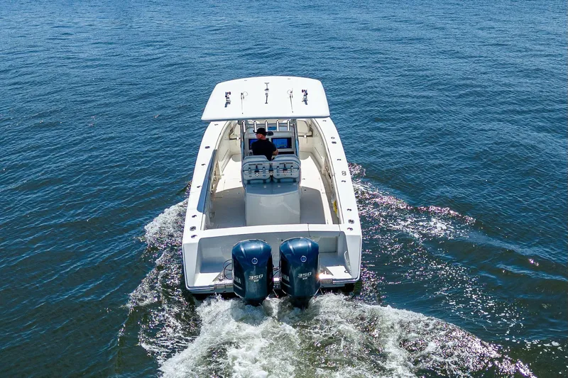  Yacht Photos Pics 2013 Jupiter 34 boat cruising on open water, rear view with dual Yamaha engines.