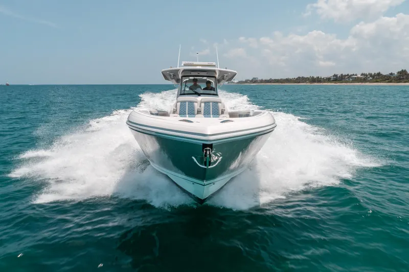  Yacht Photos Pics 2021 Intrepid 407 Nomad SE cruising on open water, creating a dynamic wake.