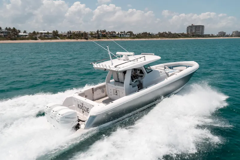  Yacht Photos Pics 2021 Intrepid 407 Nomad SE boat cruising on ocean with scenic coastline background.
