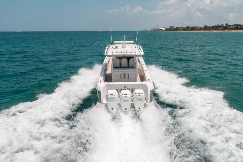  Yacht Photos Pics 2021 Intrepid 407 Nomad SE cruising on open water, rear view.