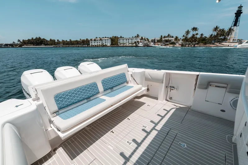  Yacht Photos Pics 2021 Intrepid 407 Nomad SE boat with spacious deck, scenic coastal view.