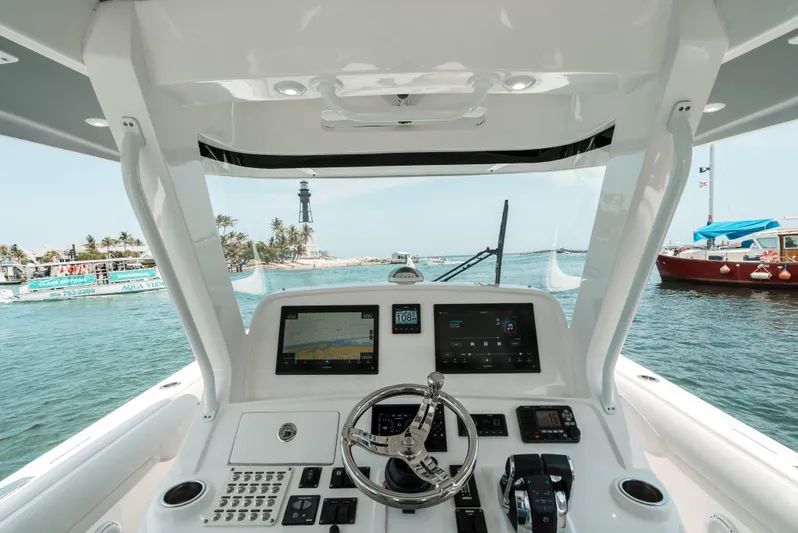  Yacht Photos Pics 2021 Intrepid 407 Nomad SE helm with navigation screens, steering wheel, and ocean view.