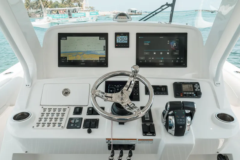  Yacht Photos Pics 2021 Intrepid 407 Nomad SE boat dashboard with navigation screens and controls.