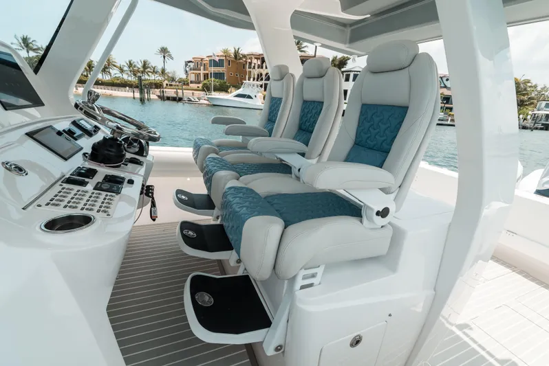  Yacht Photos Pics Luxury seating on 2021 Intrepid 407 Nomad SE boat, featuring modern helm controls.