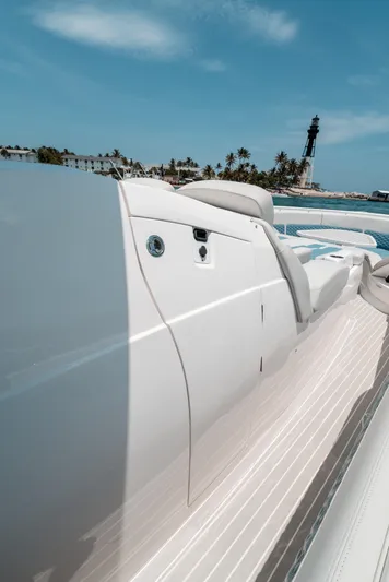  Yacht Photos Pics 2021 Intrepid 407 Nomad SE boat near a lighthouse and palm trees.