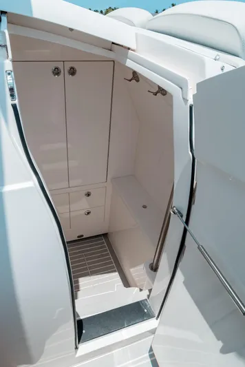  Yacht Photos Pics 2021 Intrepid 407 Nomad SE boat interior with storage cabinets and sleek design.