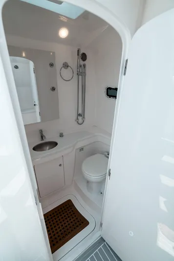  Yacht Photos Pics 2021 Intrepid 407 Nomad SE boat bathroom with sink, toilet, and shower.