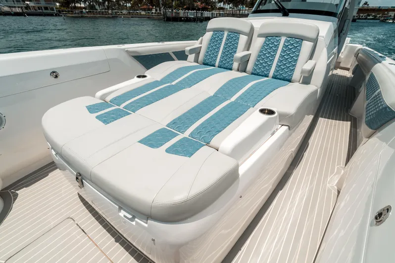  Yacht Photos Pics 2021 Intrepid 407 Nomad SE boat with luxurious sunbed and blue accents on deck.