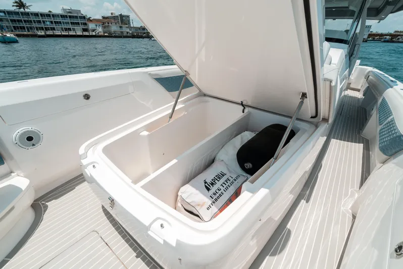  Yacht Photos Pics 2021 Intrepid 407 Nomad SE boat with open storage compartment on deck.
