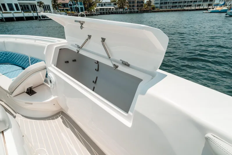  Yacht Photos Pics 2021 Intrepid 407 Nomad SE boat with open storage compartment on deck.