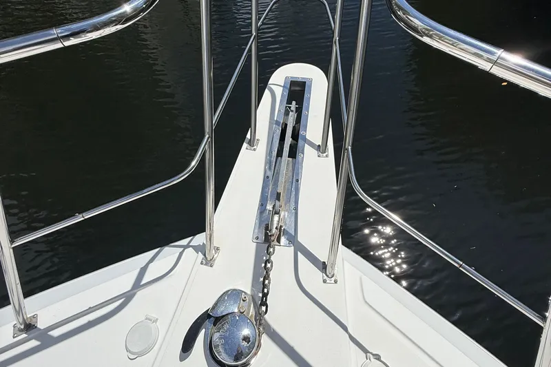 The Motley Crew Yacht Photos Pics Bow of 2003 Rival 5700 Navigator boat with anchor chain and railing.