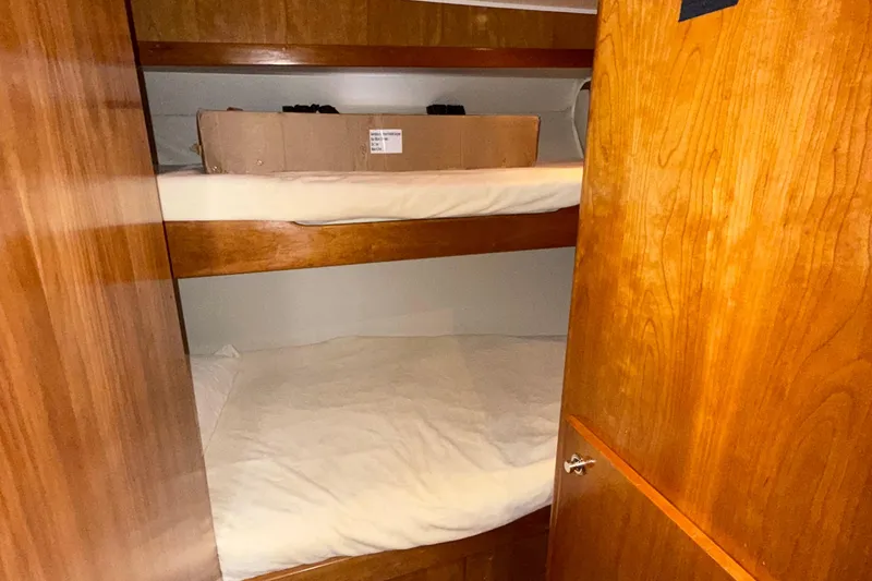 The Motley Crew Yacht Photos Pics Bunk beds in 2003 Rival 5700 Navigator boat cabin with wooden interior.