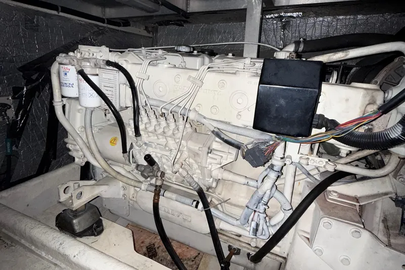 The Motley Crew Yacht Photos Pics Engine compartment of a 2003 Rival 5700 Navigator, showcasing wiring and components.