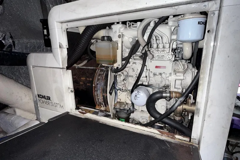 The Motley Crew Yacht Photos Pics Engine compartment of a 2003 Rival 5700 Navigator with Kohler power system.