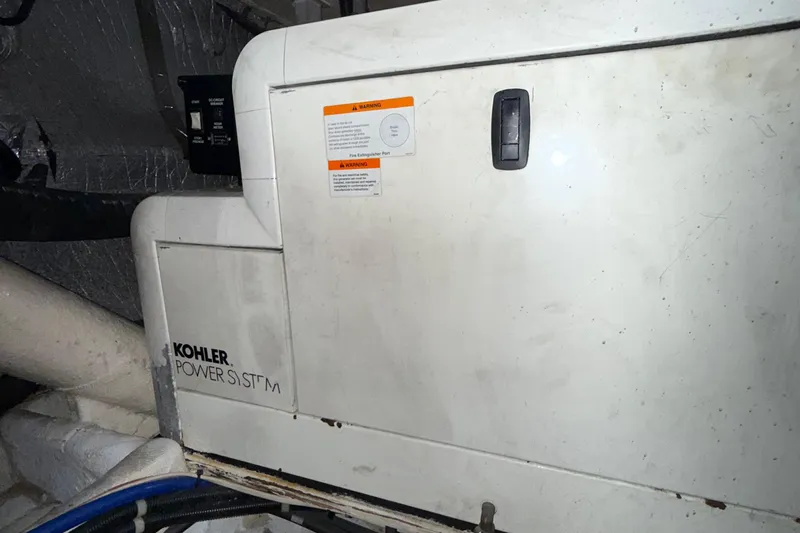 The Motley Crew Yacht Photos Pics Kohler power system in a 2003 Rival 5700 Navigator boat engine room.