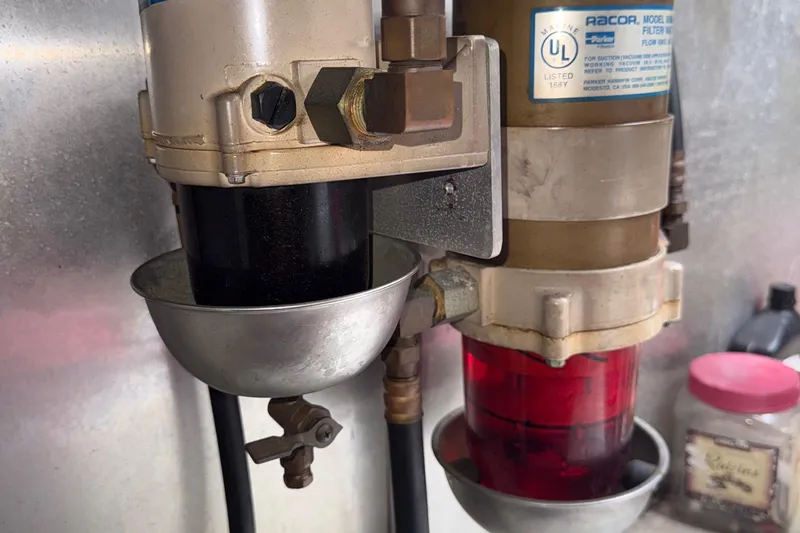 The Motley Crew Yacht Photos Pics Close-up of a 2003 Rival 5700 Navigator engine component with visible filters and labels.