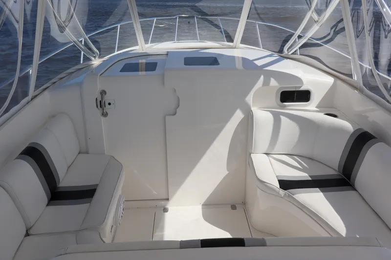 Good Karma Yacht Photos Pics 2006 Intrepid 377 Walk Around boat interior with white seating and sleek design.