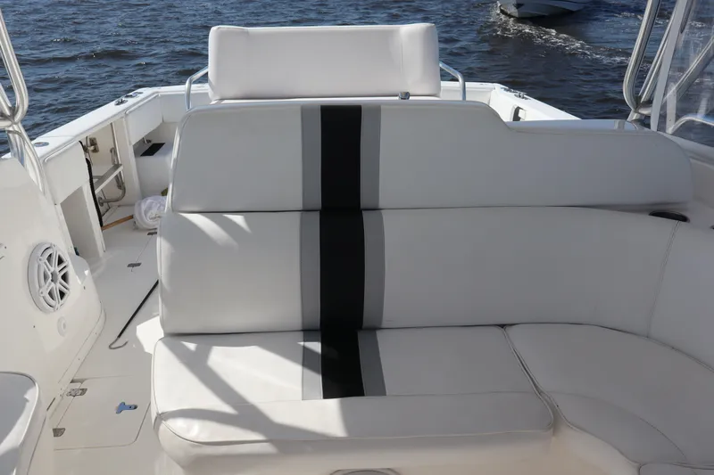 Good Karma Yacht Photos Pics 2006 Intrepid 377 Walk Around boat interior with white seating and black accents.