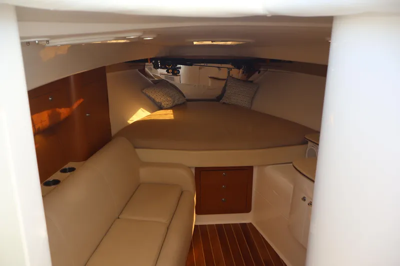 Good Karma Yacht Photos Pics Interior cabin of 2006 Intrepid 377 Walk Around with cozy seating and bed.