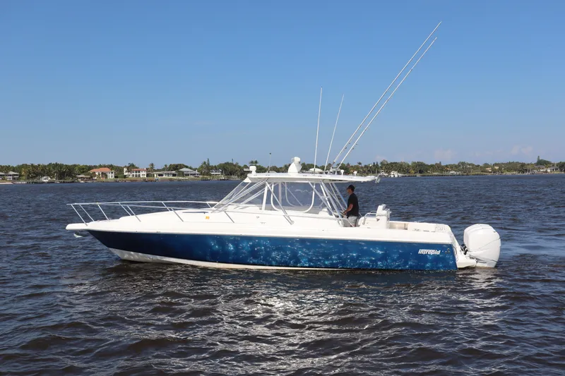 Good Karma Yacht Photos Pics 2006 Intrepid 377 Walk Around boat cruising on a sunny day.