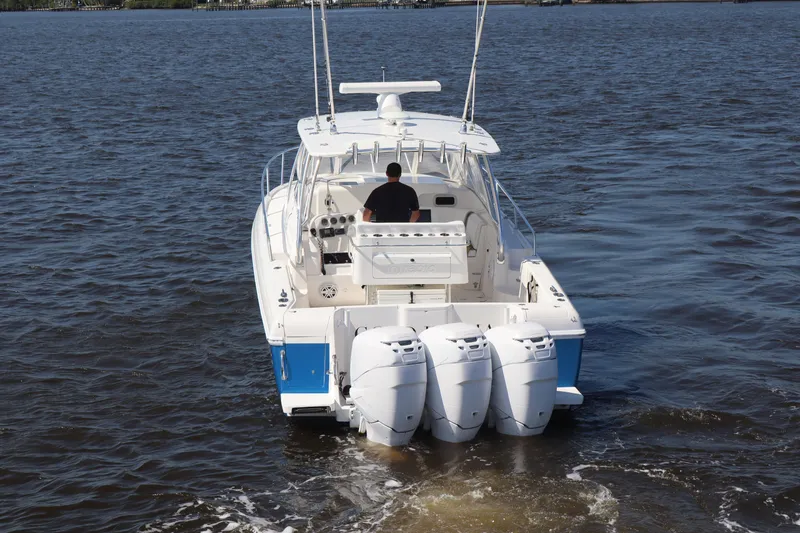 Good Karma Yacht Photos Pics 2006 Intrepid 377 Walk Around boat with triple outboard engines on open water.