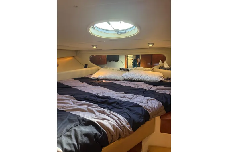 Borabora III Yacht Photos Pics 2007 Regal Commodore 3760 IB cabin interior with cozy bed and porthole window.