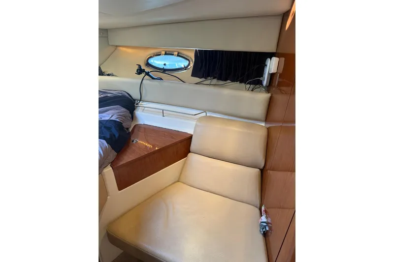 Borabora III Yacht Photos Pics Interior of 2007 Regal Commodore 3760 IB yacht with beige seating and porthole window.