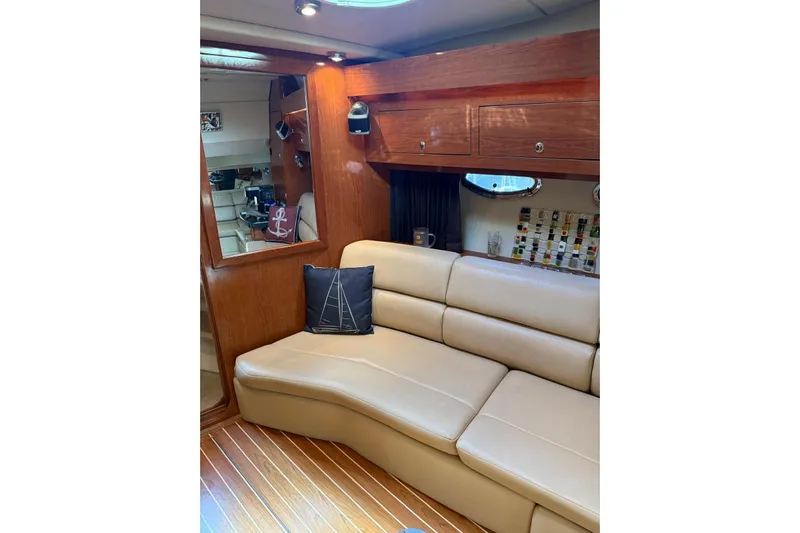 Borabora III Yacht Photos Pics Luxurious interior of 2007 Regal Commodore 3760 IB yacht with leather seating and wooden cabinetry.