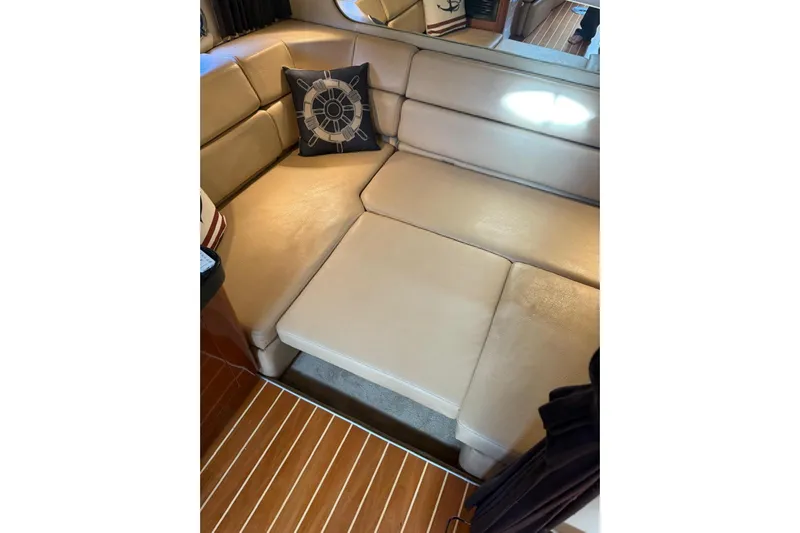 Borabora III Yacht Photos Pics 2007 Regal Commodore 3760 IB interior with beige leather seating and nautical-themed pillow.