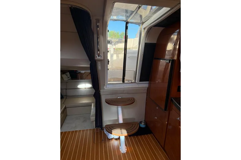 Borabora III Yacht Photos Pics Interior of 2007 Regal Commodore 3760 IB yacht with wooden flooring and seating area.