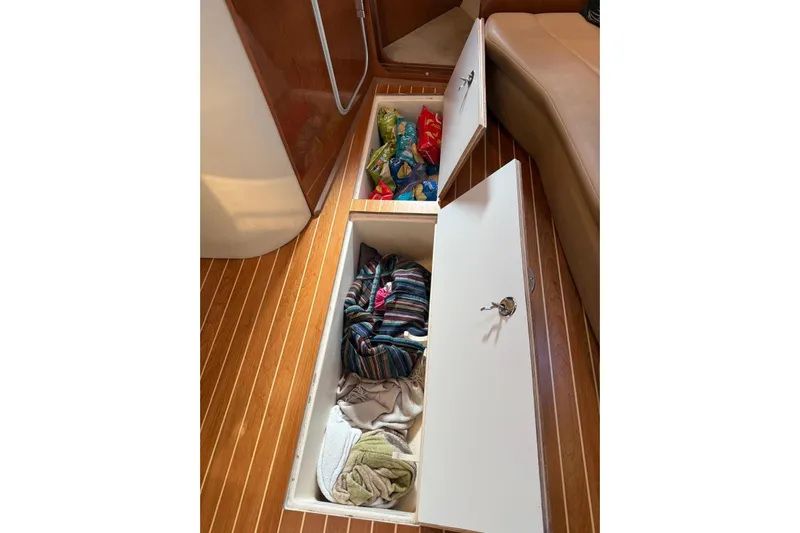 Borabora III Yacht Photos Pics 2007 Regal Commodore 3760 IB boat interior with open floor storage compartments.