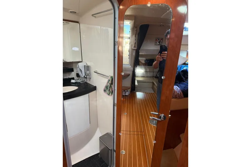 Borabora III Yacht Photos Pics 2007 Regal Commodore 3760 IB yacht interior with wooden flooring and bathroom.