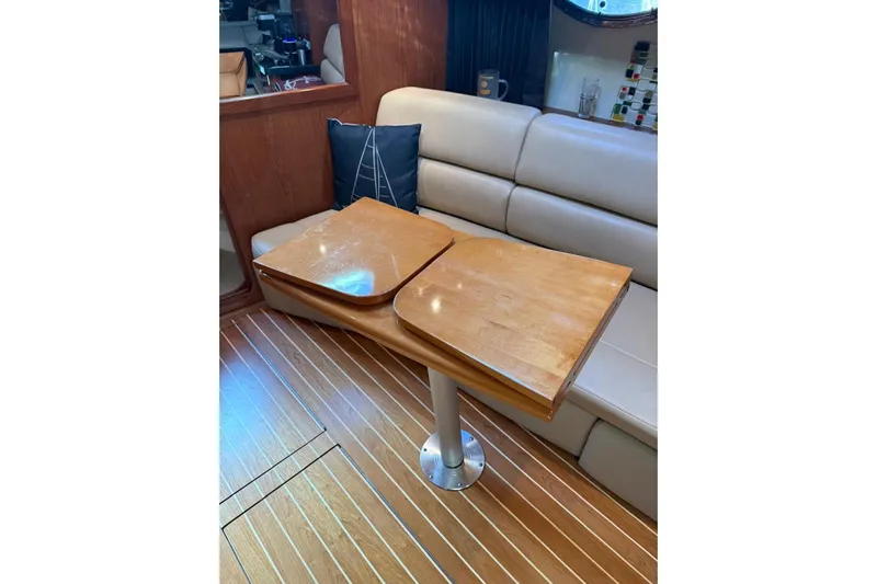 Borabora III Yacht Photos Pics 2007 Regal Commodore 3760 IB interior with wooden table and beige seating.