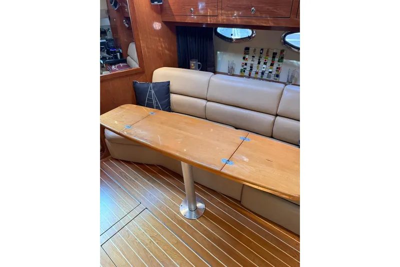 Borabora III Yacht Photos Pics 2007 Regal Commodore 3760 IB interior with wooden table and beige seating.