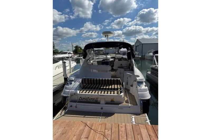 Borabora III Yacht Photos Pics 2007 Regal Commodore 3760 IB yacht docked under a partly cloudy sky.