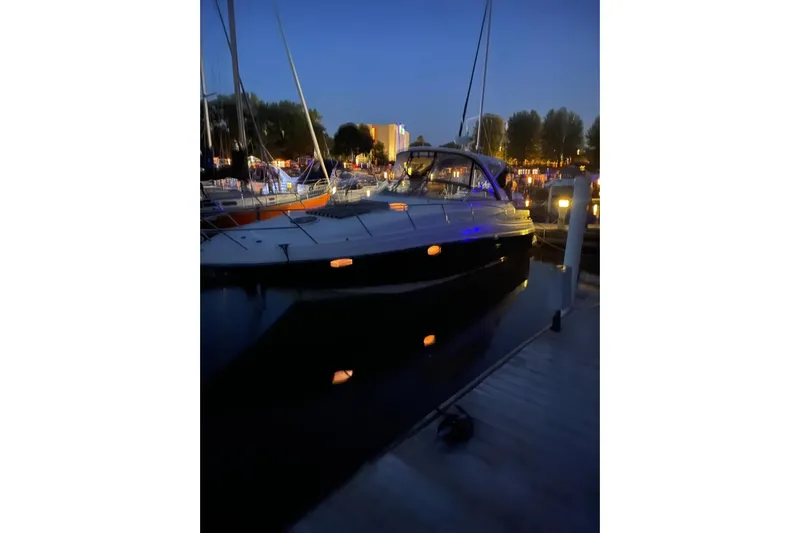 Borabora III Yacht Photos Pics 2007 Regal Commodore 3760 IB yacht docked at night, illuminated by soft lights.